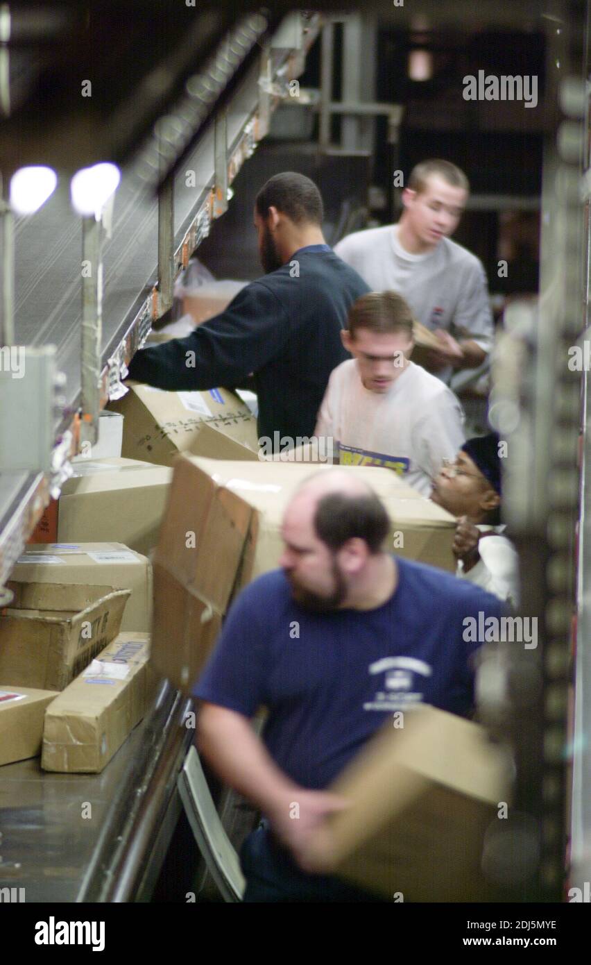 United Parcel Servce employees sort through packages to be shipped throughout the world Thursday, December 14, 2000 at Philadelphia International Airp Stock Photo