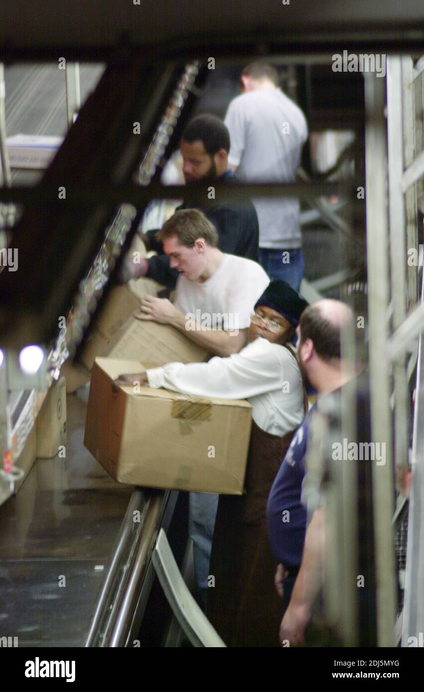 United Parcel Servce employees sort through packages to be shipped throughout the world Thursday, December 14, 2000 at Philadelphia International Airp Stock Photo