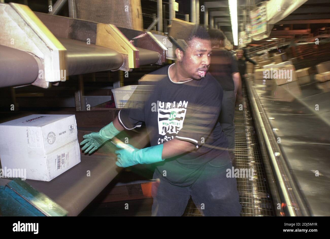 United Parcel Servce employees sort through packages to be shipped throughout the world Thursday, December 14, 2000 at Philadelphia International Airp Stock Photo