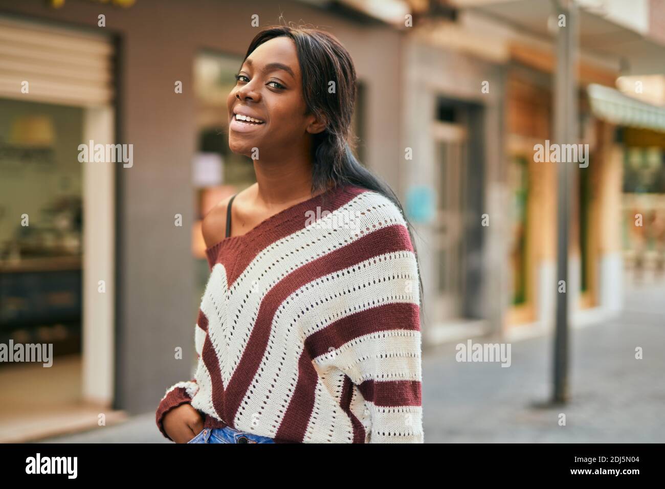 Young african american woman smiling happy standing at the city Stock ...