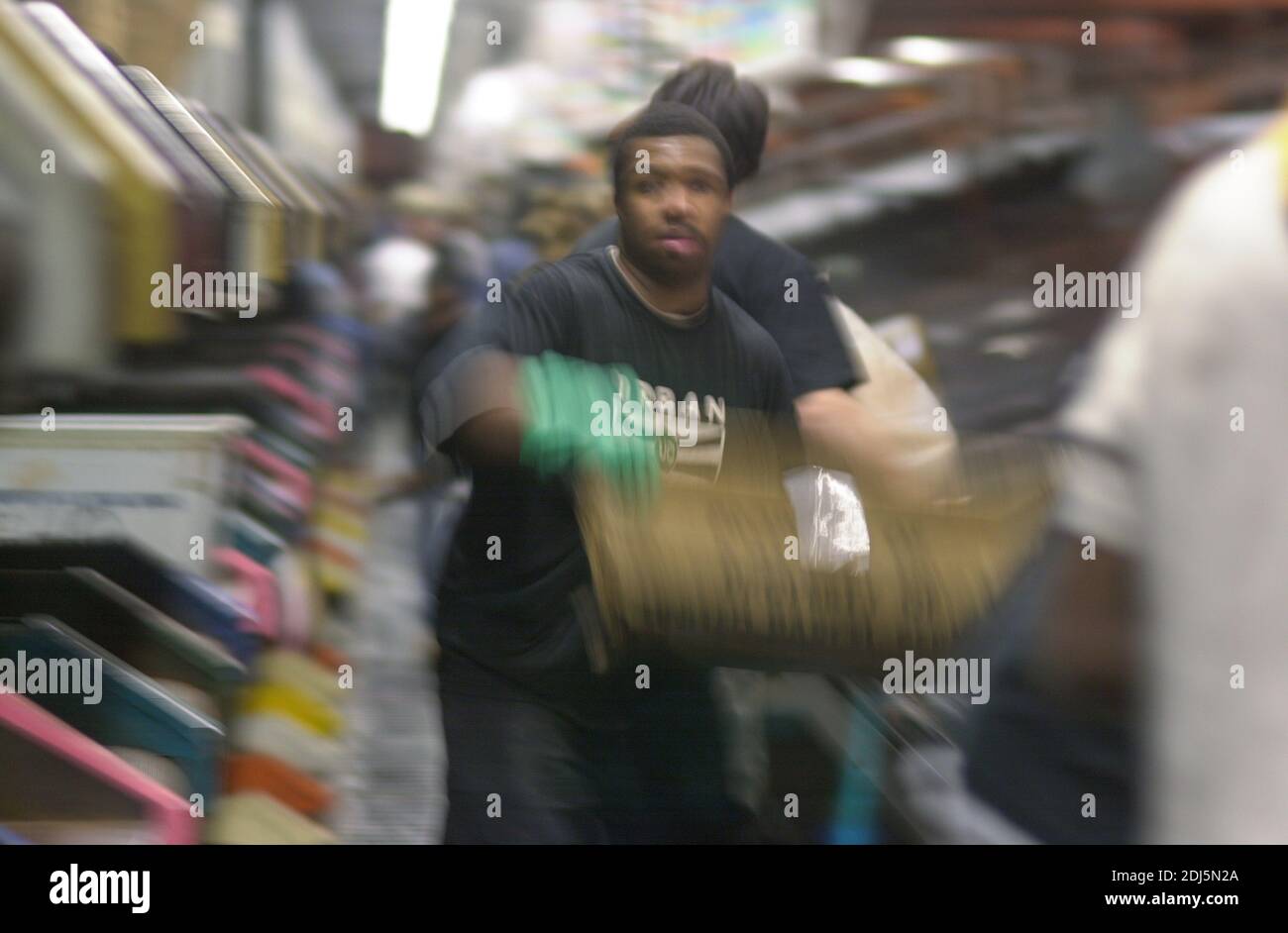 United Parcel Servce employees sort through packages to be shipped throughout the world Thursday, December 14, 2000 at Philadelphia International Airp Stock Photo