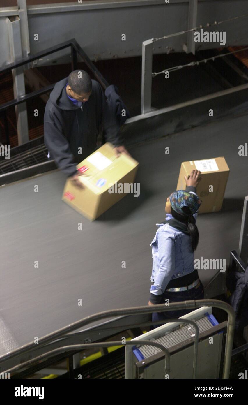 United Parcel Servce employees sort through packages to be shipped throughout the world Thursday, December 14, 2000 at Philadelphia International Airp Stock Photo