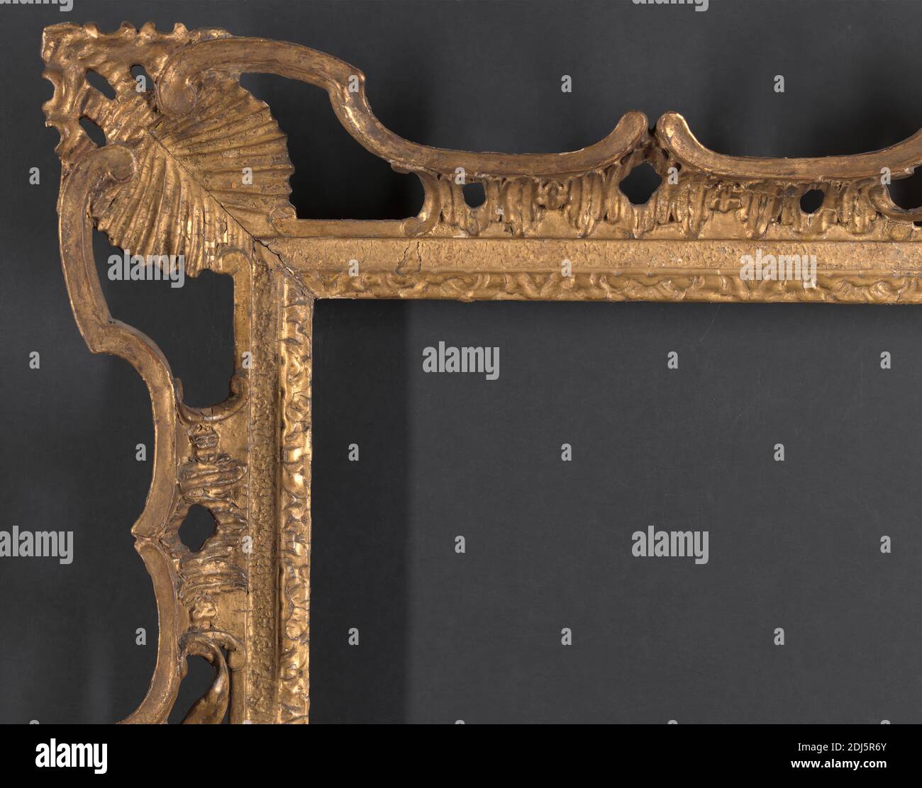 British, Provincial Rococo frame, Unknown framemaker, 3rd quarter of 18th century, Carved wood, later oil gilding over original gilding and sanded frieze Stock Photo