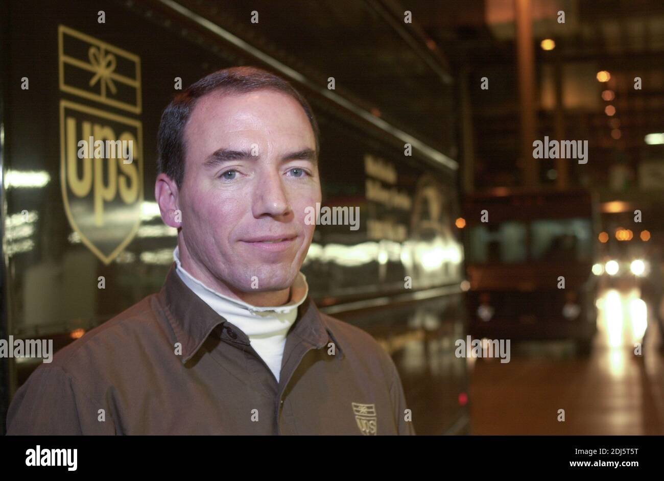 A UPS driver poses for a portrait as United Parcel Servce employees sort through packages to be shipped throughout the world Thursday, December 07, 20 Stock Photo