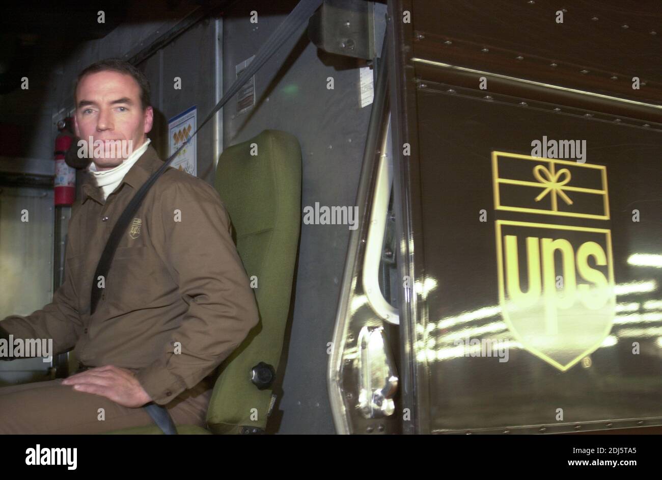 A UPS driver poses for a portrait as United Parcel Servce employees sort through packages to be shipped throughout the world Thursday, December 07, 20 Stock Photo