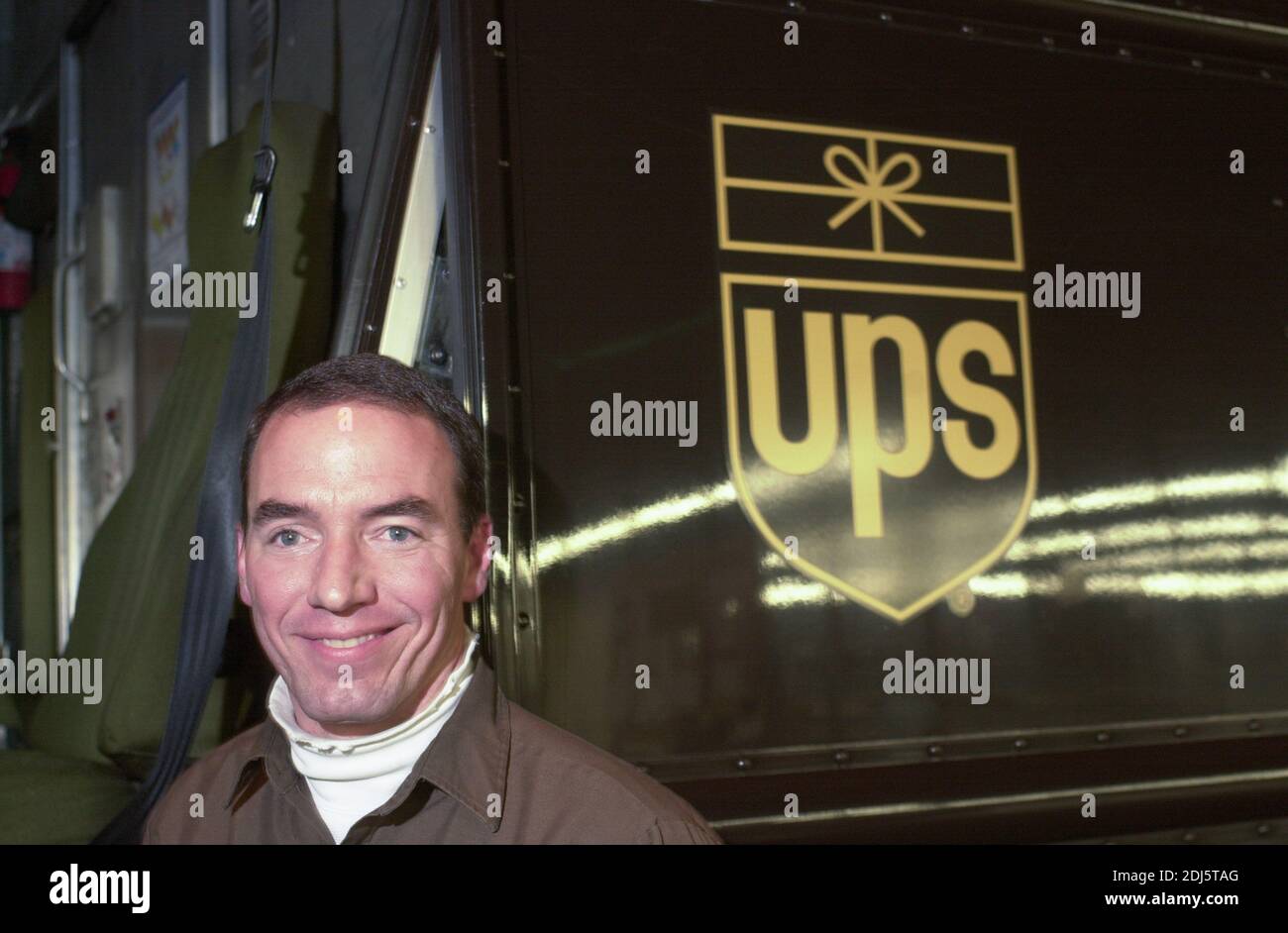 A UPS driver poses for a portrait as United Parcel Servce employees sort through packages to be shipped throughout the world Thursday, December 07, 20 Stock Photo