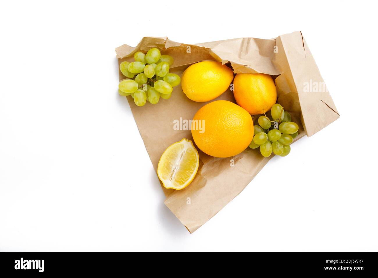 Fruits in paper bag, top view, white background Stock Photo - Alamy