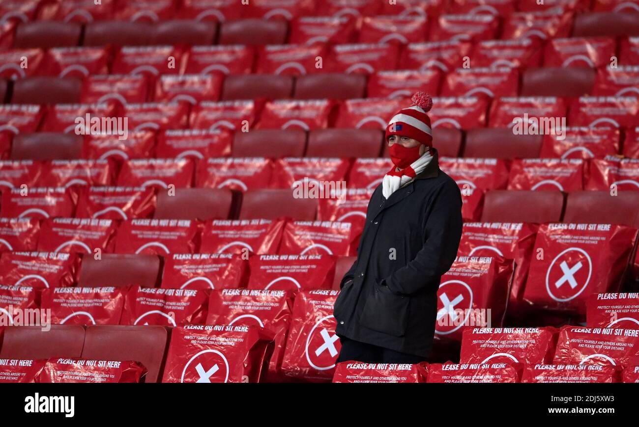 Arsenal Fan Wearing A Face Mask Takes His Seat In The Stands For The Match Before The Premier League Match At Emirates Stadium London Stock Photo Alamy