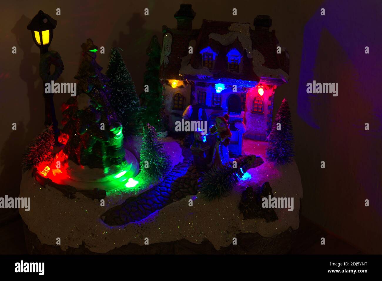 The representation of a Santa Claus Village. With colored lights and ...