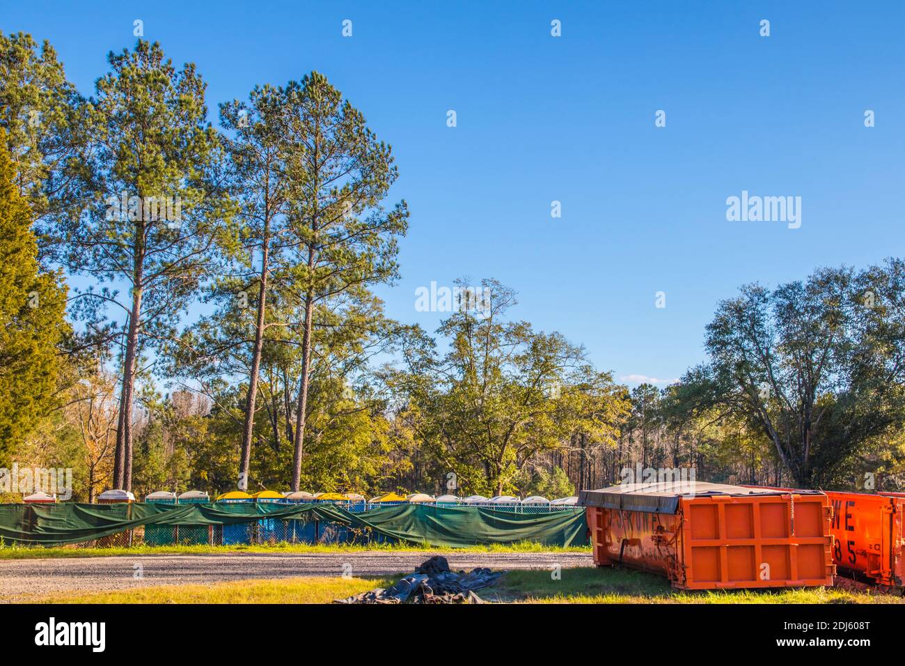 Augusta, Ga USA - 11 04 20: Waste containers and portable restrooms stored on a lot Stock Photo