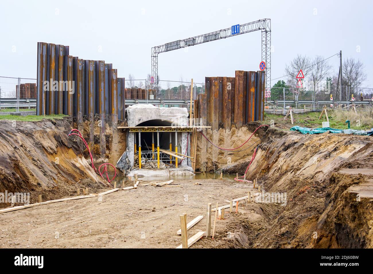 construction of a pedestrian tunnel under the highway, temporary metal retaining wall support the foundation Stock Photo