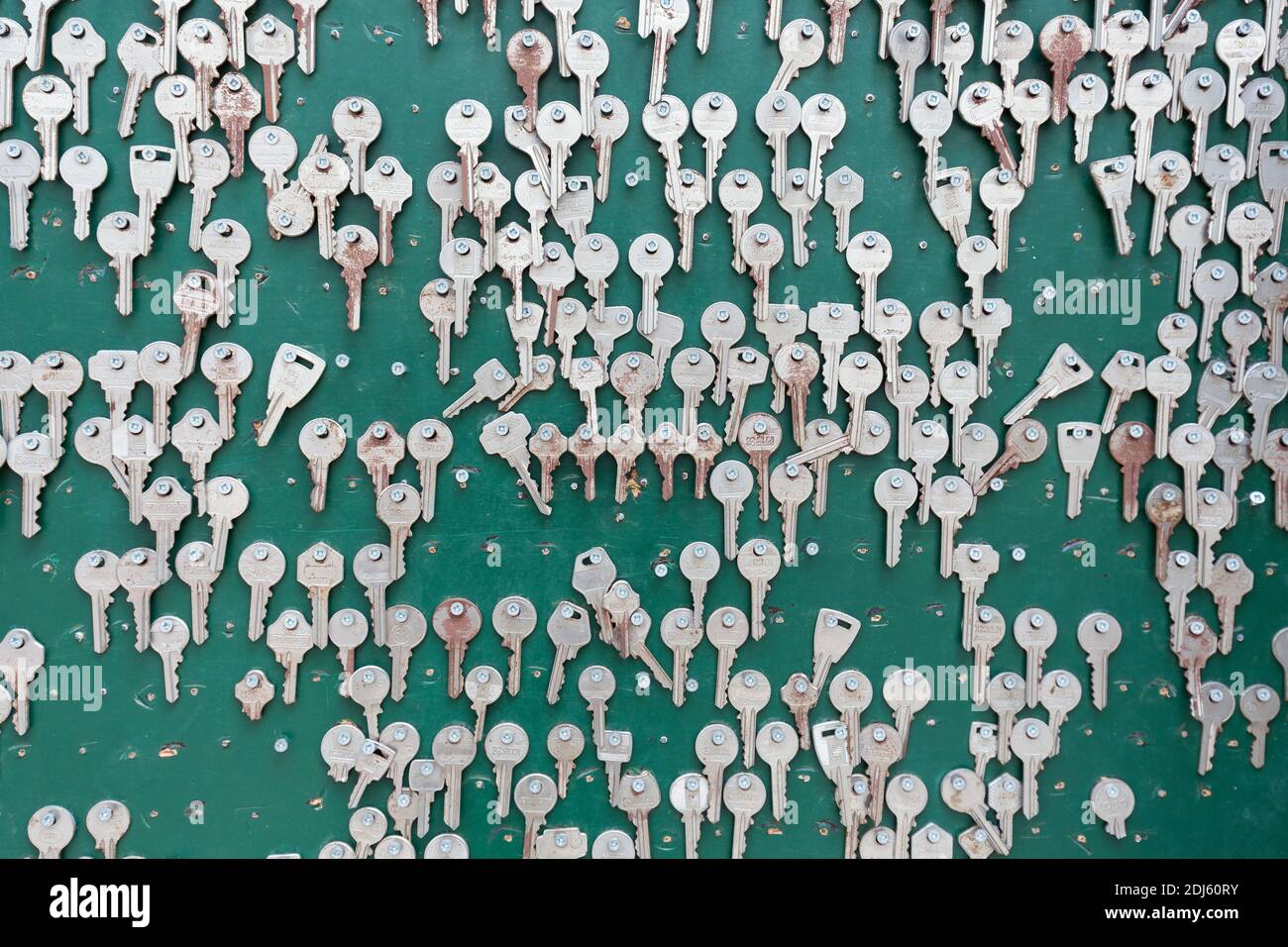 Green wall with many metal keys background Stock Photo