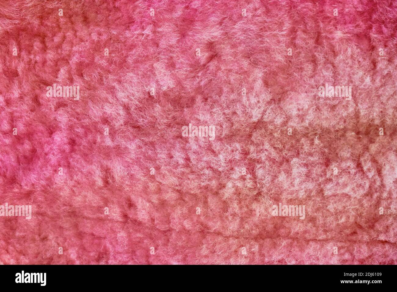 Red sheepskin texture, fur closeup. Background wool of the sheep pink