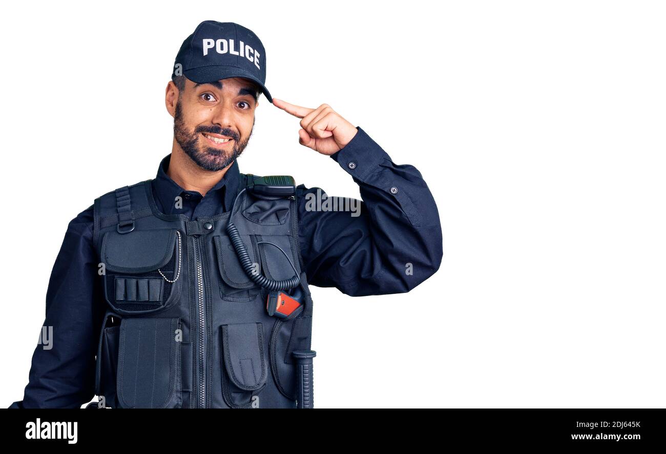 Young hispanic man wearing police uniform smiling pointing to head with one finger, great idea or thought, good memory Stock Photo