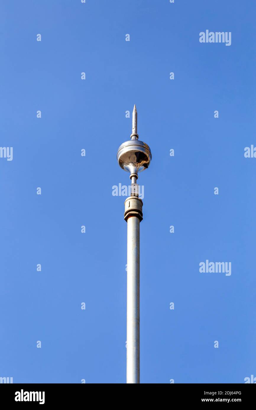 Lightning rod or lightning conductor installed on the rooftop to protect the structure from a lightning strike. Stock Photo