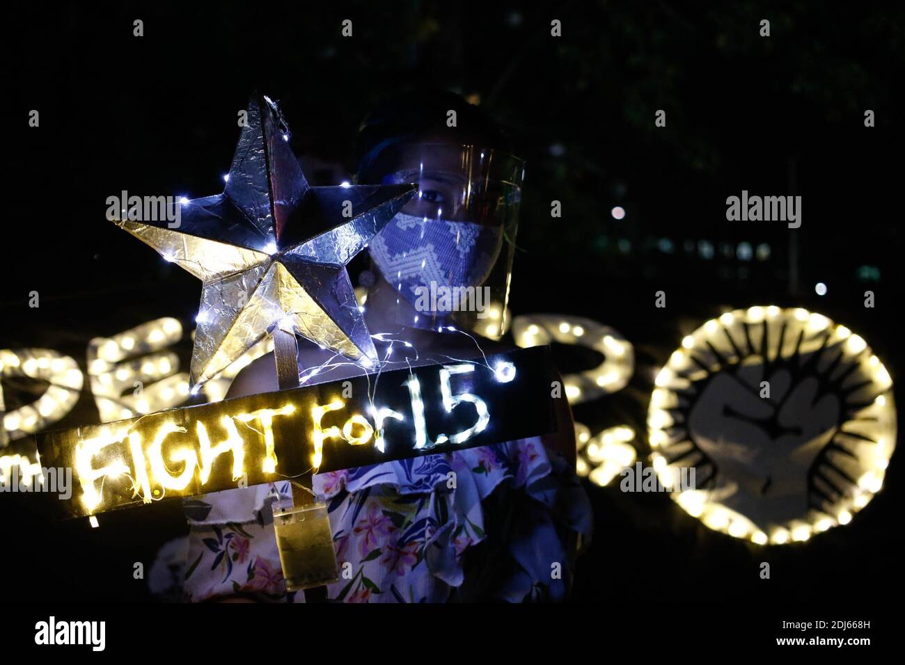 Climate activists lit candles and held LED lighting banners on December 11th 2020. This activity commemorates the five year anniversary of the Paris Agreement with a call to fight for 1.5 and to end the killing of environmental defenders. Quezon City, Philippines. Stock Photo