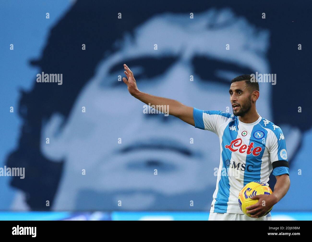 Naples, Italy. 13th Dec, 2020. Napoli's Algerian defender Faouzi Ghoulam gestures under a giant banner depicting Diego Armando Maradona during the Serie A football match SSC Napoli vs UC Sampdoria. Napoli won 2-1. Credit: Independent Photo Agency/Alamy Live News Stock Photo