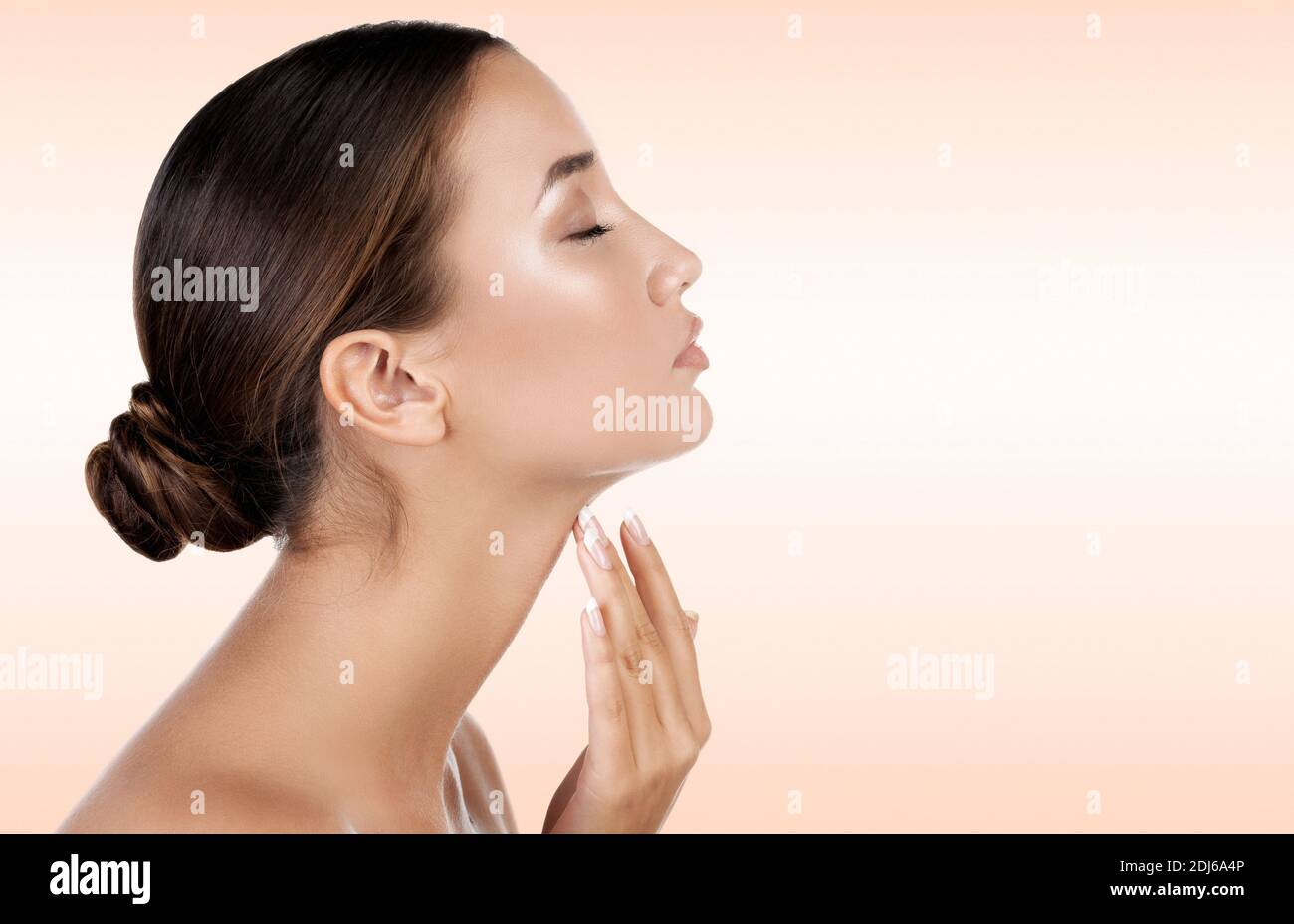 Pretty woman touching her neck Stock Photo - Alamy