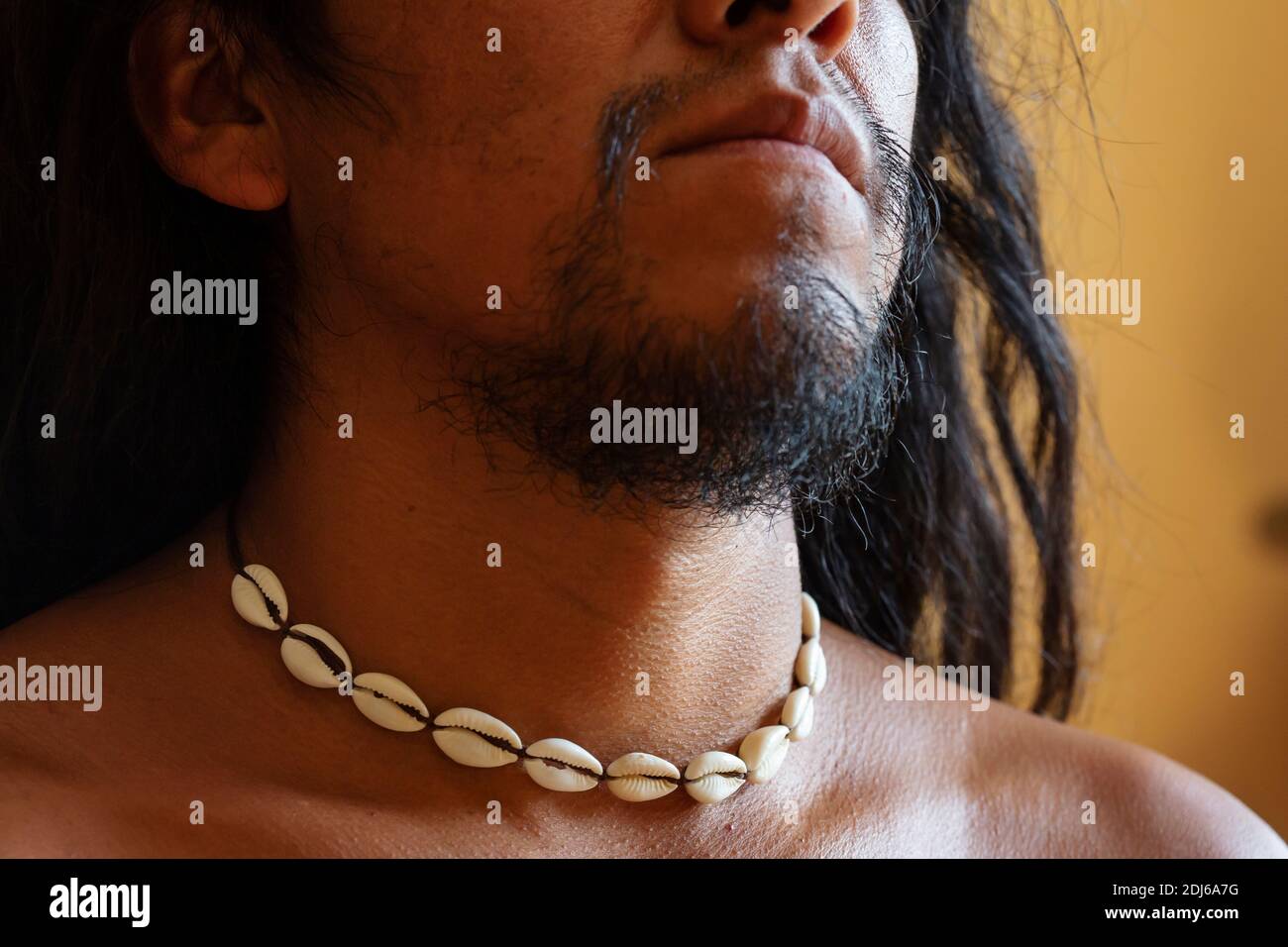 Closeup of native male neck wearing natural white shell choker