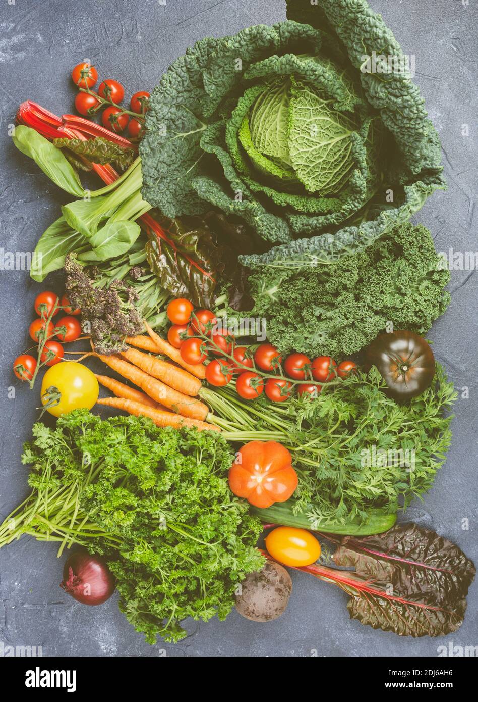 Variety of organic vegetables on blue table Stock Photo