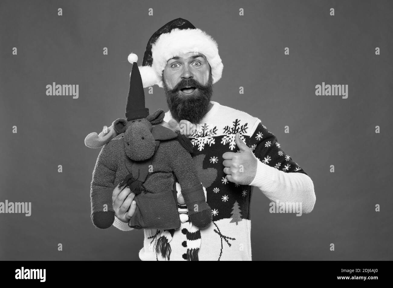 Santas favorite deer. Happy hipster give like with reindeer toy. Bearded man show thumbs up like hand. Like from Santa. Celebrate Christmas and New year. Like if you believe in Santa Claus. Stock Photo