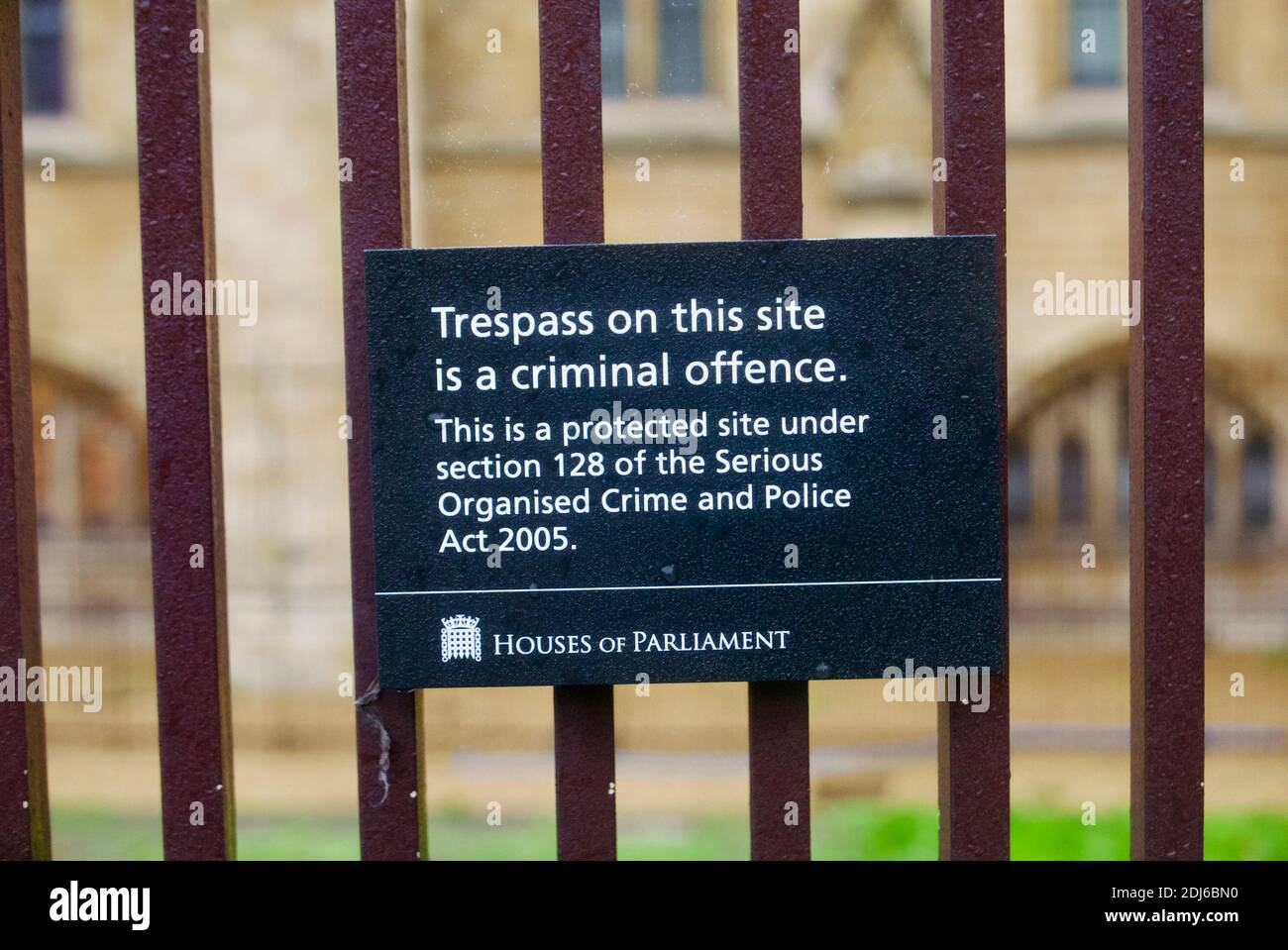 Sign at Palace of Westminster stating trespass a criminal offence under Section 128 Serious Organised Crime and Police Act 2005. UK Parliament London Stock Photo