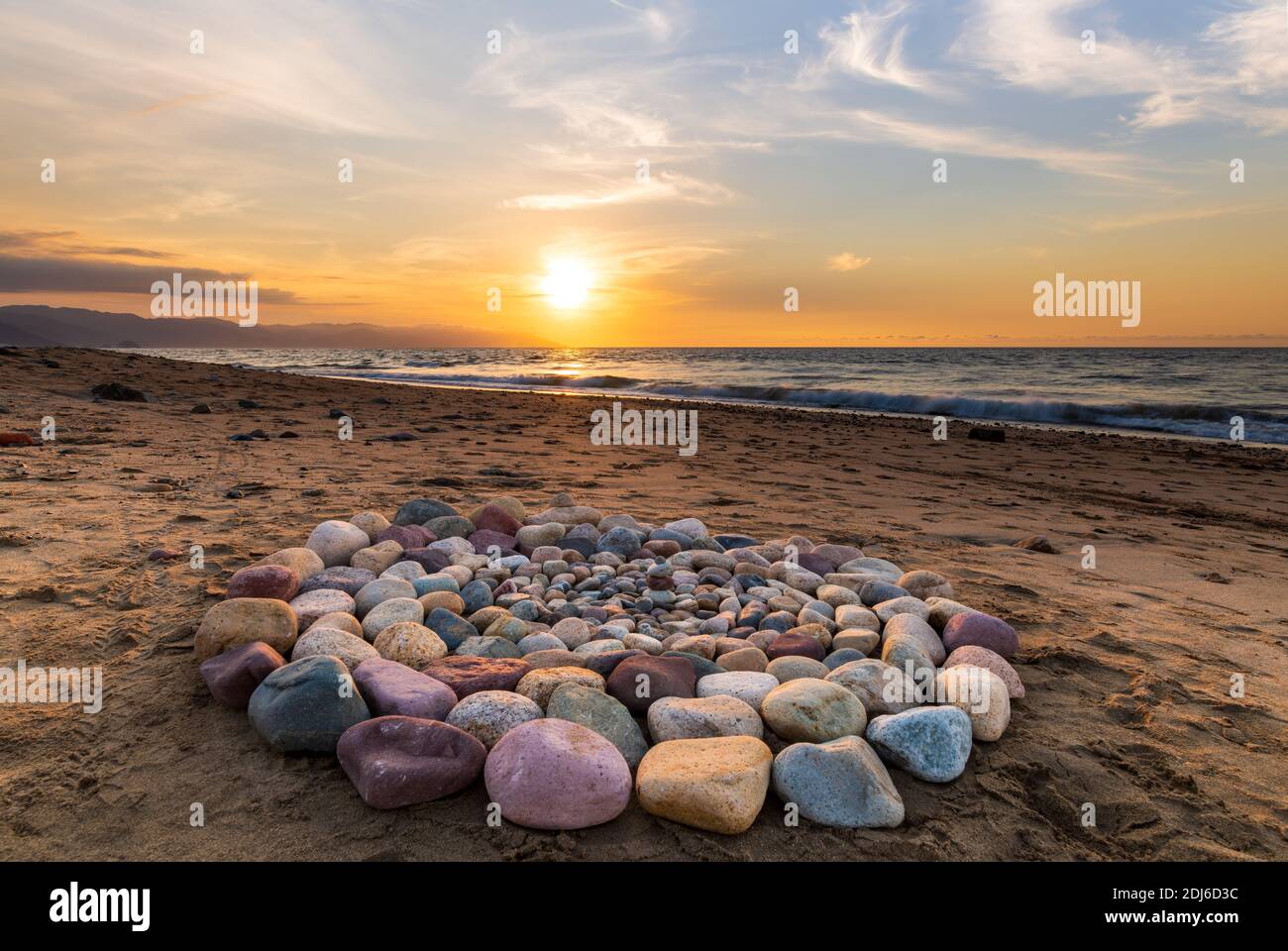 A Group of Stones Are Arranged on the Beach in a Ceremonial Ritualistic Pattern Stock Photo