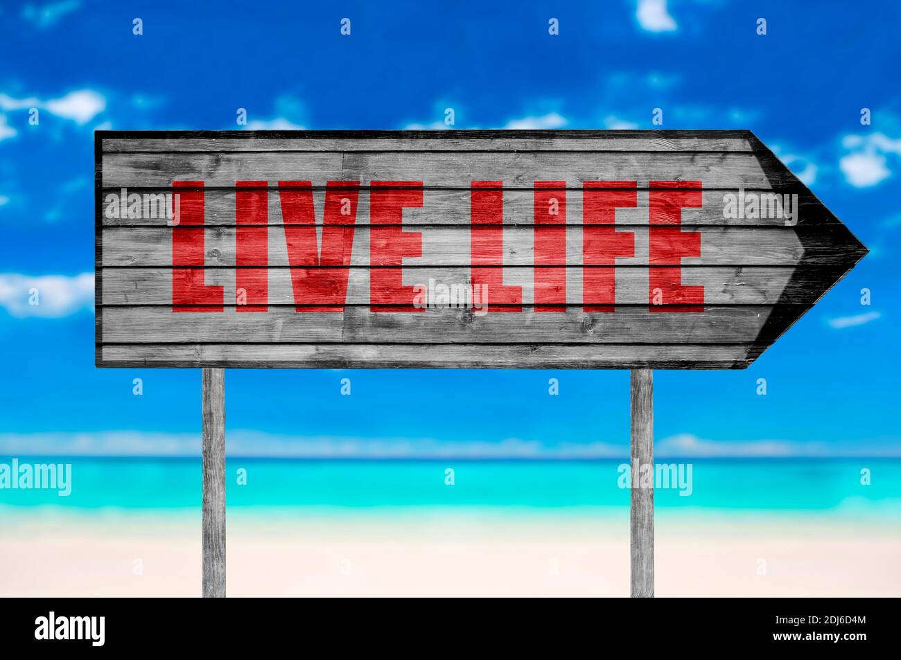 Red Live Life wooden sign with a beach on background Stock Photo