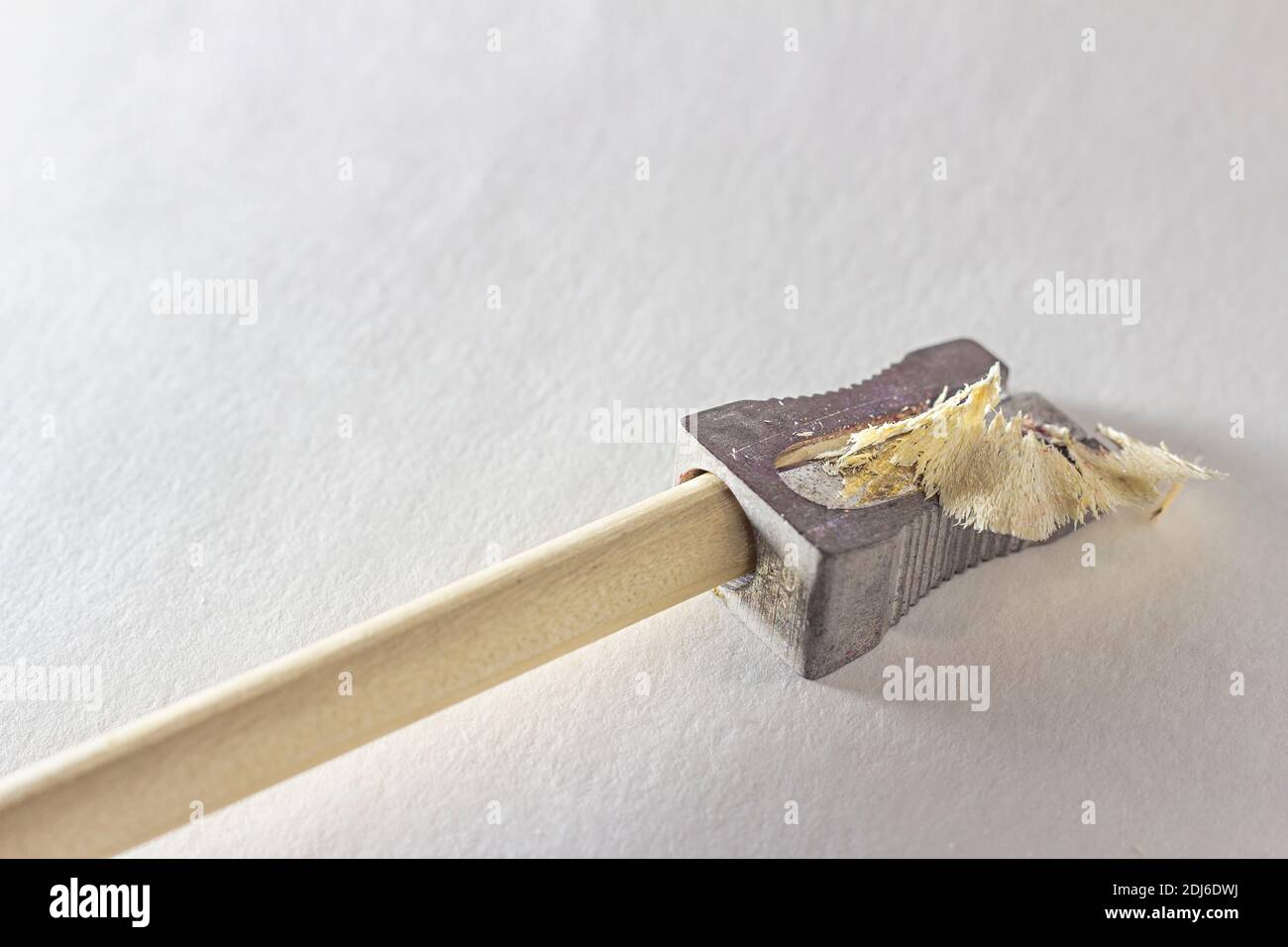 Broken pencil with metal sharpener, broken lead rod and shavings on