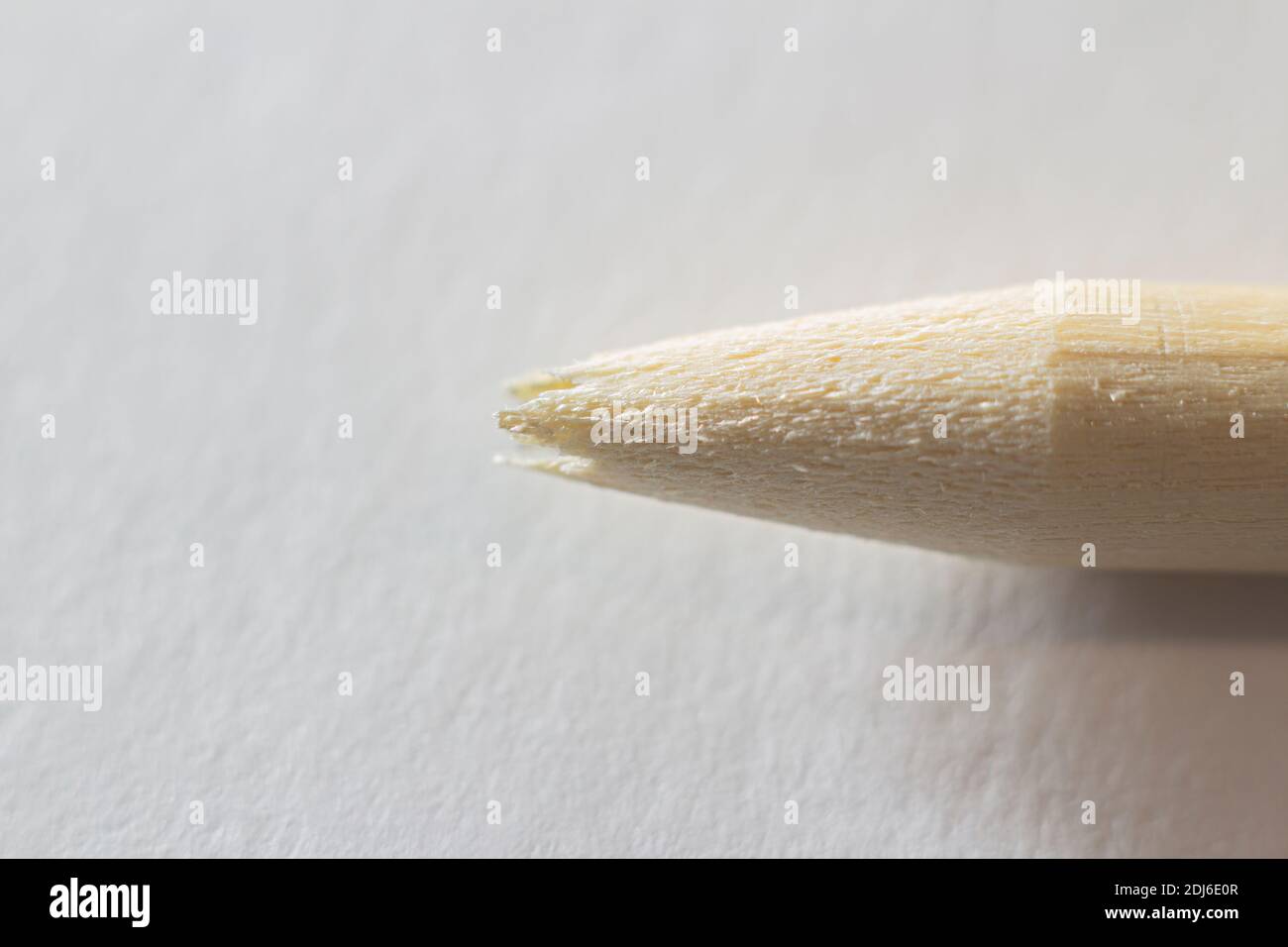 Closeup view of a broken pencil without lead rod on a white paper background Stock Photo