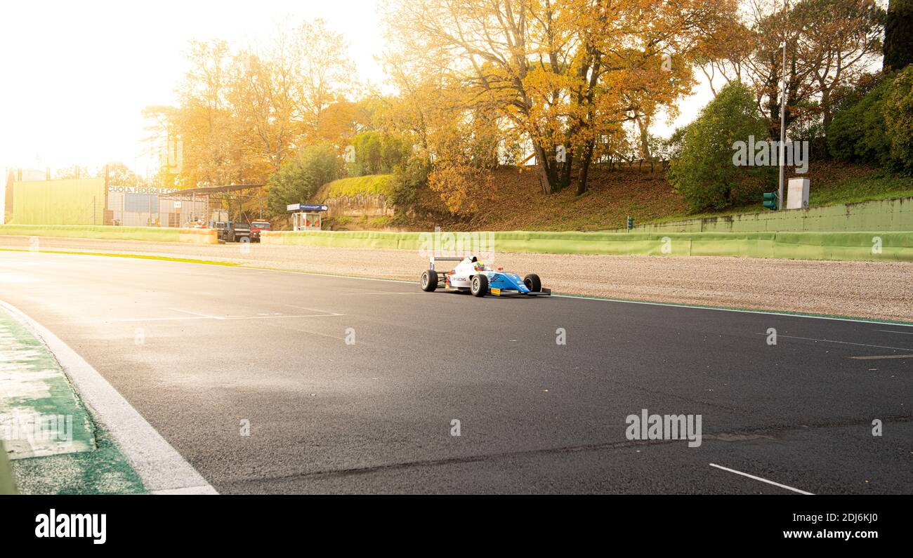 Car motorsport speed action racing on asphalt track sun flare light effect Stock Photo