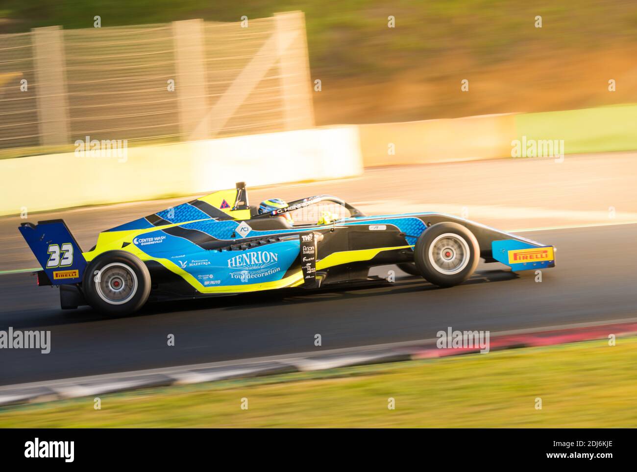 Racing car single seater modern formula in action close up blurred motion background sun flare effect Stock Photo