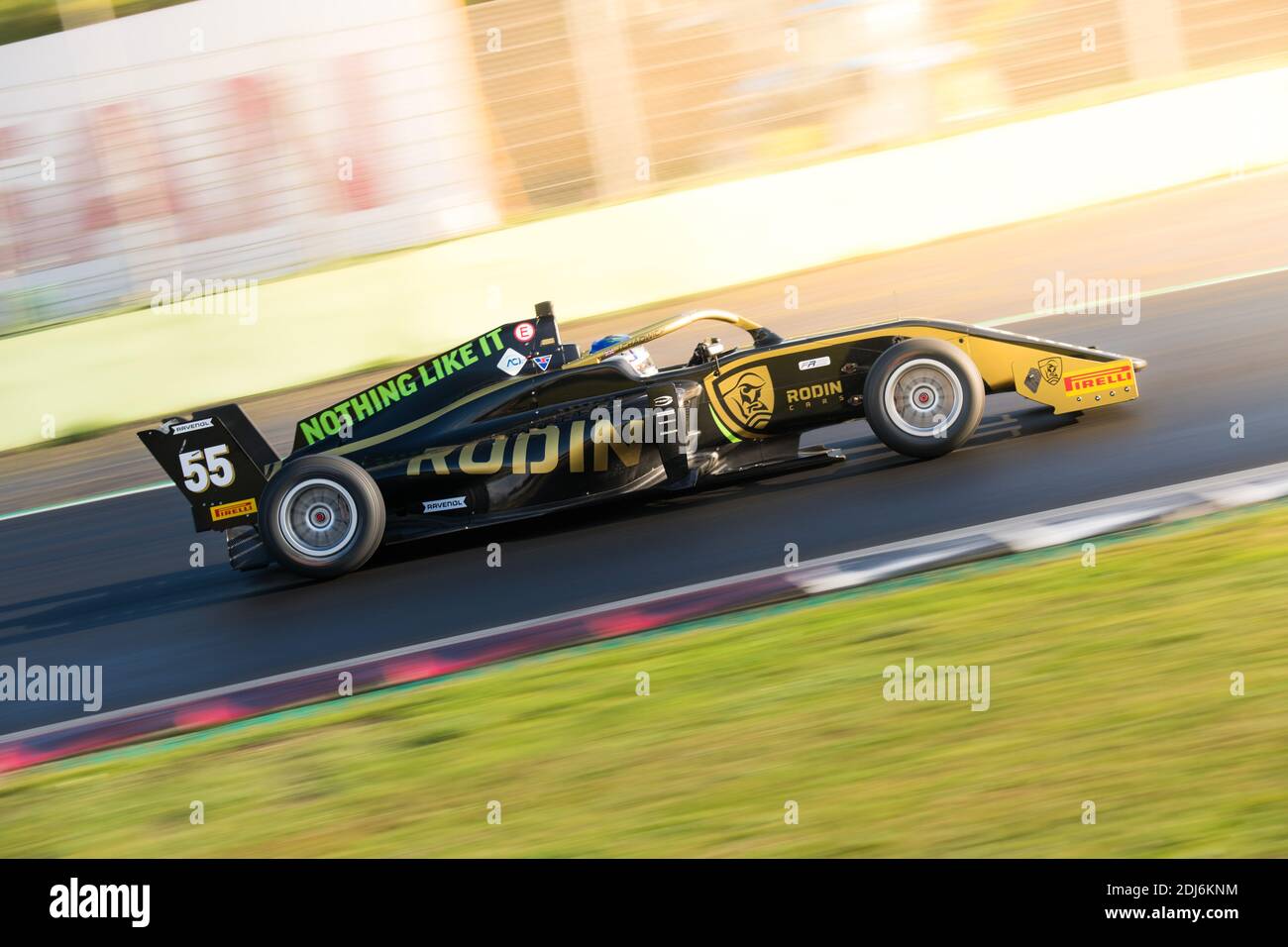 Racing car single seater modern formula in action close up blurred motion background sun flare effect Stock Photo