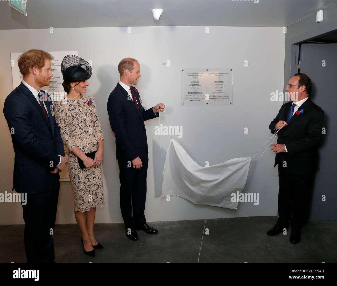 France's President Francois Hollande, right, and Prince William, the Duke of Cambridge, pull a curtain to unveil a commemorative plate inside the World War I Thiepval monument while his wife Kate, the Duchess of Cambridge, and Britain's Prince Harry, left, look on prior to the Somme centenary commemorations in Thiepval, northern France, Friday, July 1st, 2016. One week after Britain's vote to leave the European Union, Prime Minister David Cameron and royal family members will stand side-by-side with France's President to celebrate their historic alliance at the centenary of the deadliest battl Stock Photo