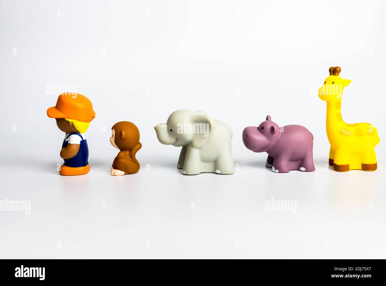 Wildlife animal toys with a human person on white background Stock Photo