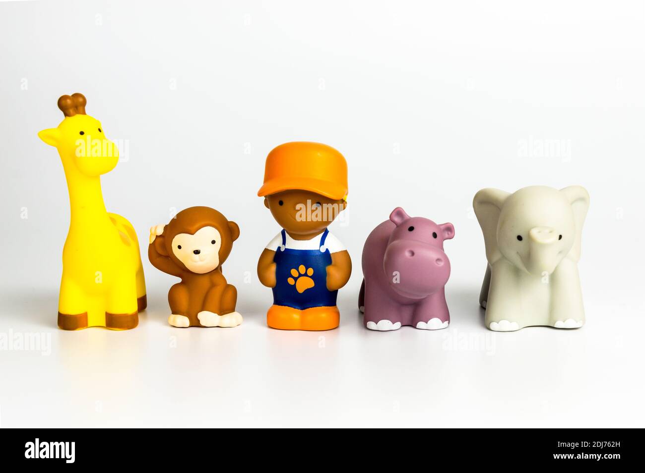Wildlife animal toys with a human person on white background Stock Photo