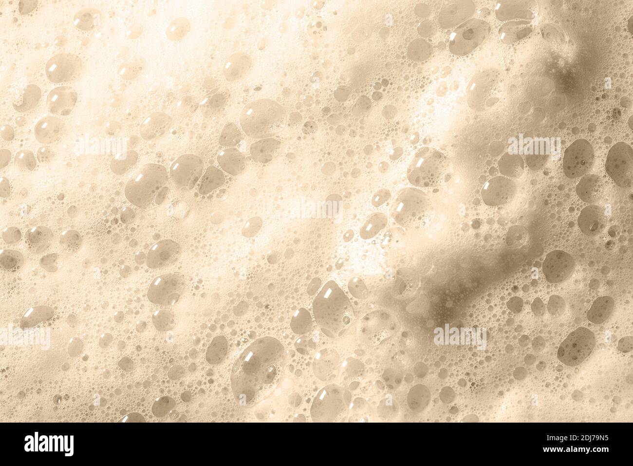 Foam bubble from soap or shampoo washing toned in Sail Champagne color trendy creative design color 2021. Stock Photo