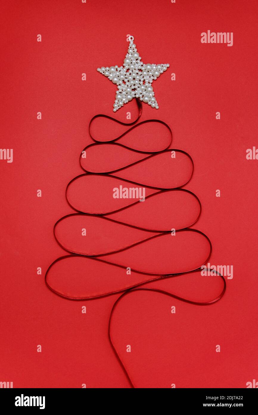 Christmas tree made of decorative white ribbon with star on top. Minimal Christmas concept Stock Photo