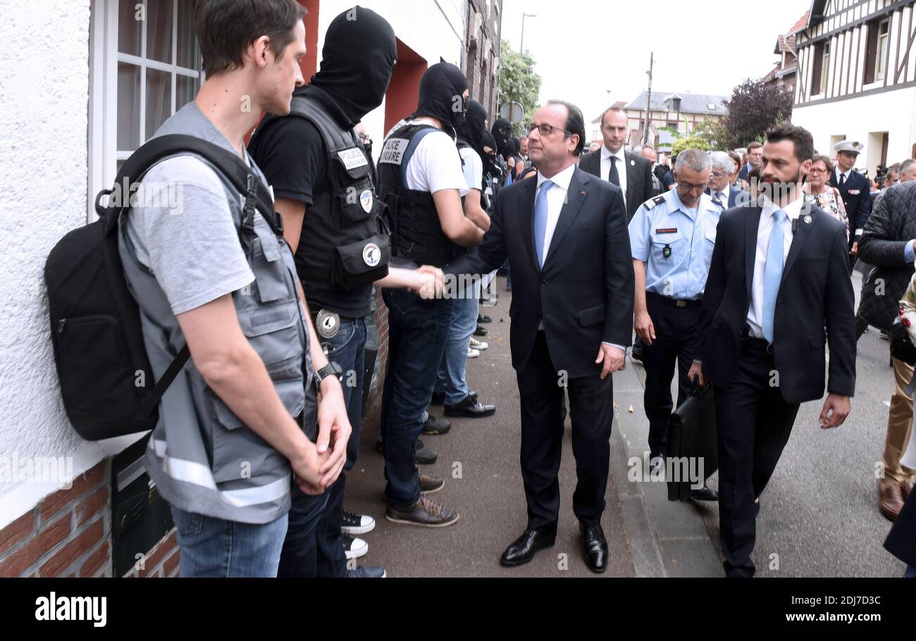French President Francois Hollande (R) shakes hands with members of the RAID, the French national police intervention group, as he arrives in Saint-Etienne-du-Rouvray, western France on July 26, 2016, after a hostage-taking at a church of the town that left the priest dead. Two men who attacked a church and slit the throat of a priest had 'claimed to be from Daesh', using the Arabic name for the Islamic State group. Police said they killed two hostage-takers in the attack in the Normandy town of Saint-Etienne-du-Rouvray, 125 kilometres (77 miles) north of Paris. Photo by Boris Maslard/Pool/ABA Stock Photo
