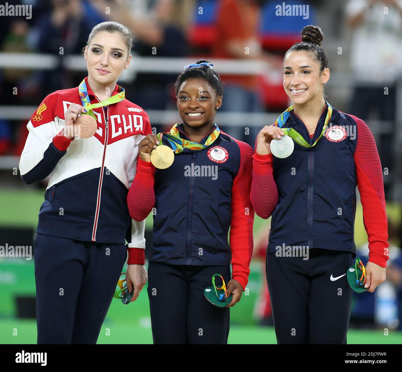 Aliya Mustafina of Russia, Simone Biles and Aly Raisman of the United States stand with their medals at the medal ceremony at the Women's Individual all around in artistic gymnastics at HSBC Arena (Arena Ol?mpica do Rio) at the 2016 Rio Summer Olympics in Rio de Janeiro, Brazil, on August 11, 2016. Simone Biles of the United States won the gold. Photo by Giuliano Bevilacqua/ABACAPRESS.COM Stock Photo