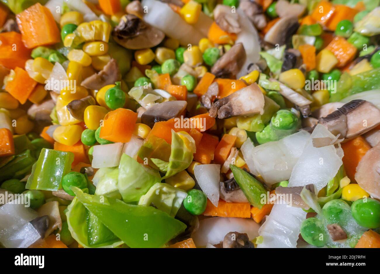 Sliced mixed vegetables being stir-friend. Stock Photo