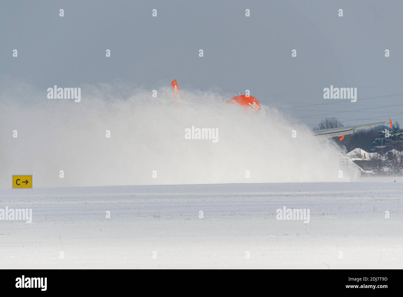 Snow covered London Southend Airport, Essex, UK, with an easyJet jet airliner plane throwing up a cloud of snow as it takes off. Enveloped in snow Stock Photo
