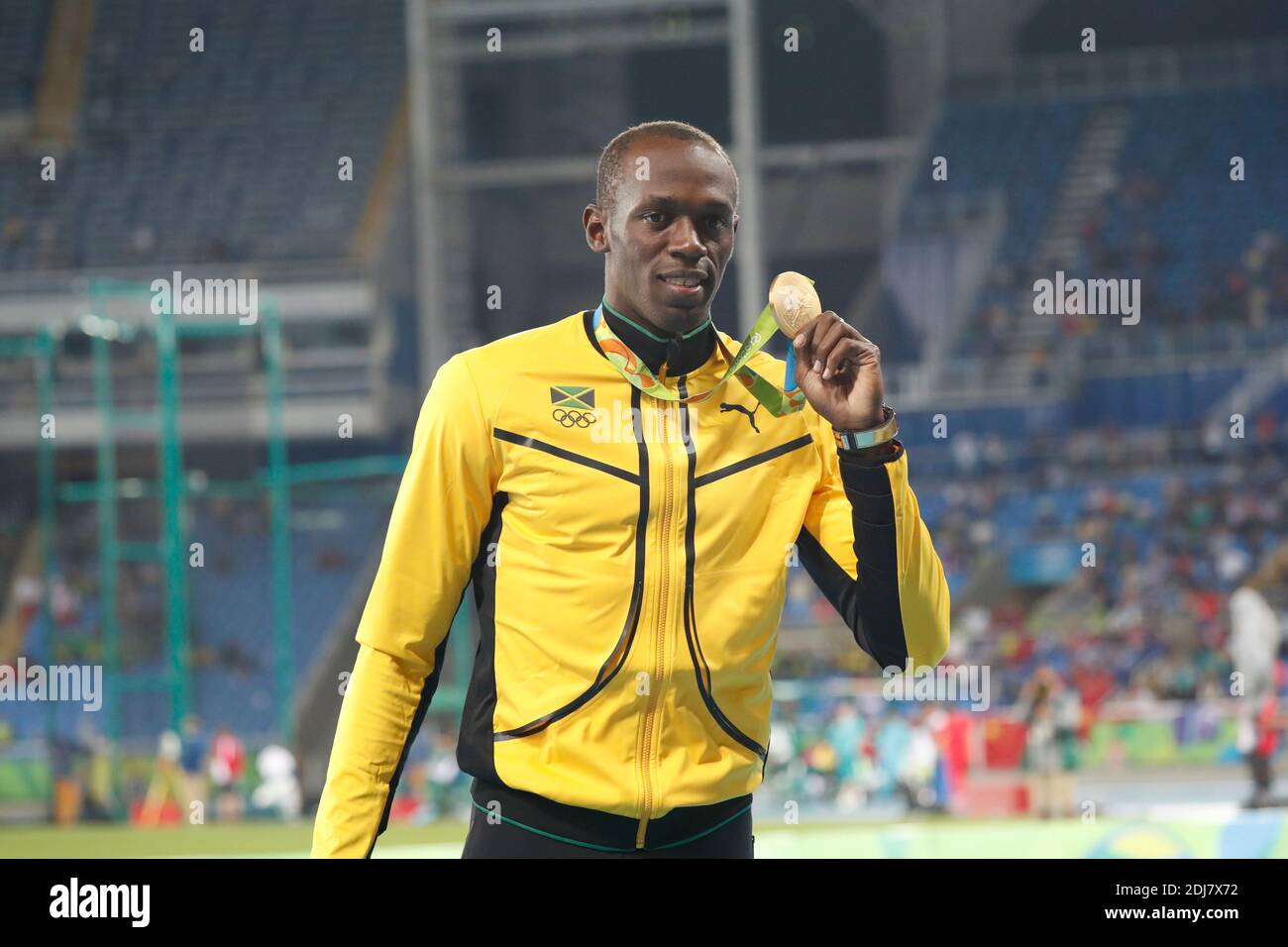 Jamaica's Usain Bolt with his Gold medal on the podium of the 100m men