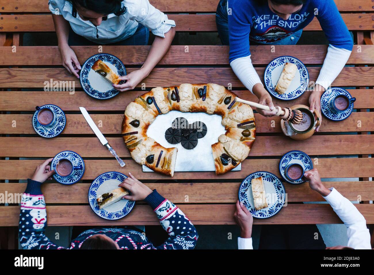Mexican people eating Rosca de reyes or Epiphany cake, Roscon de reyes ...
