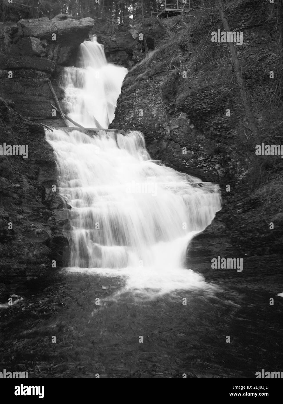 Raymondskill Falls in Milford, Pennsylvania in black and white just off US route 209 near the Delaware River.  Located in the Delaware River Natl Park Stock Photo