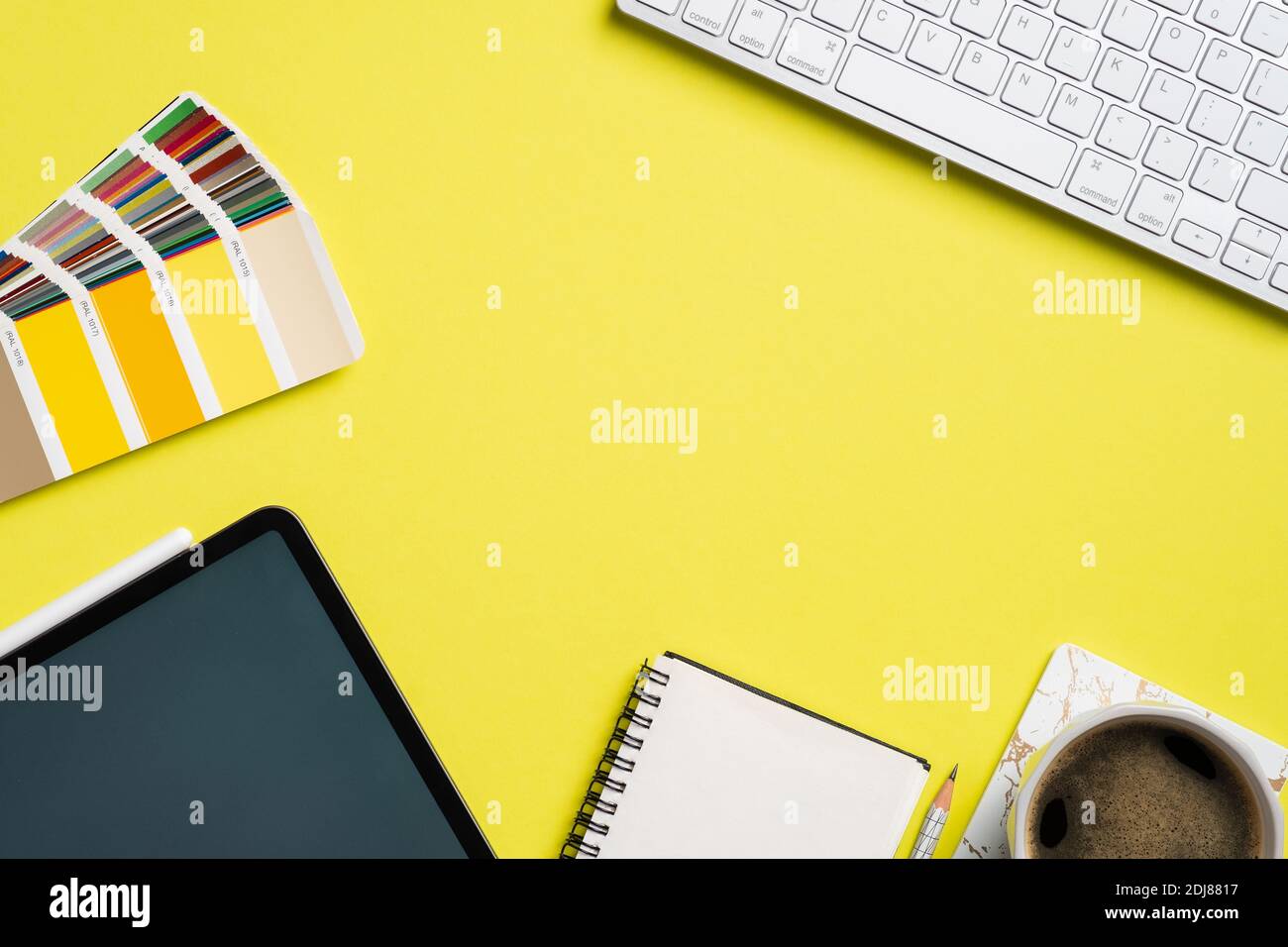 Graphic designer desk top view with RAL colors palette, tablet