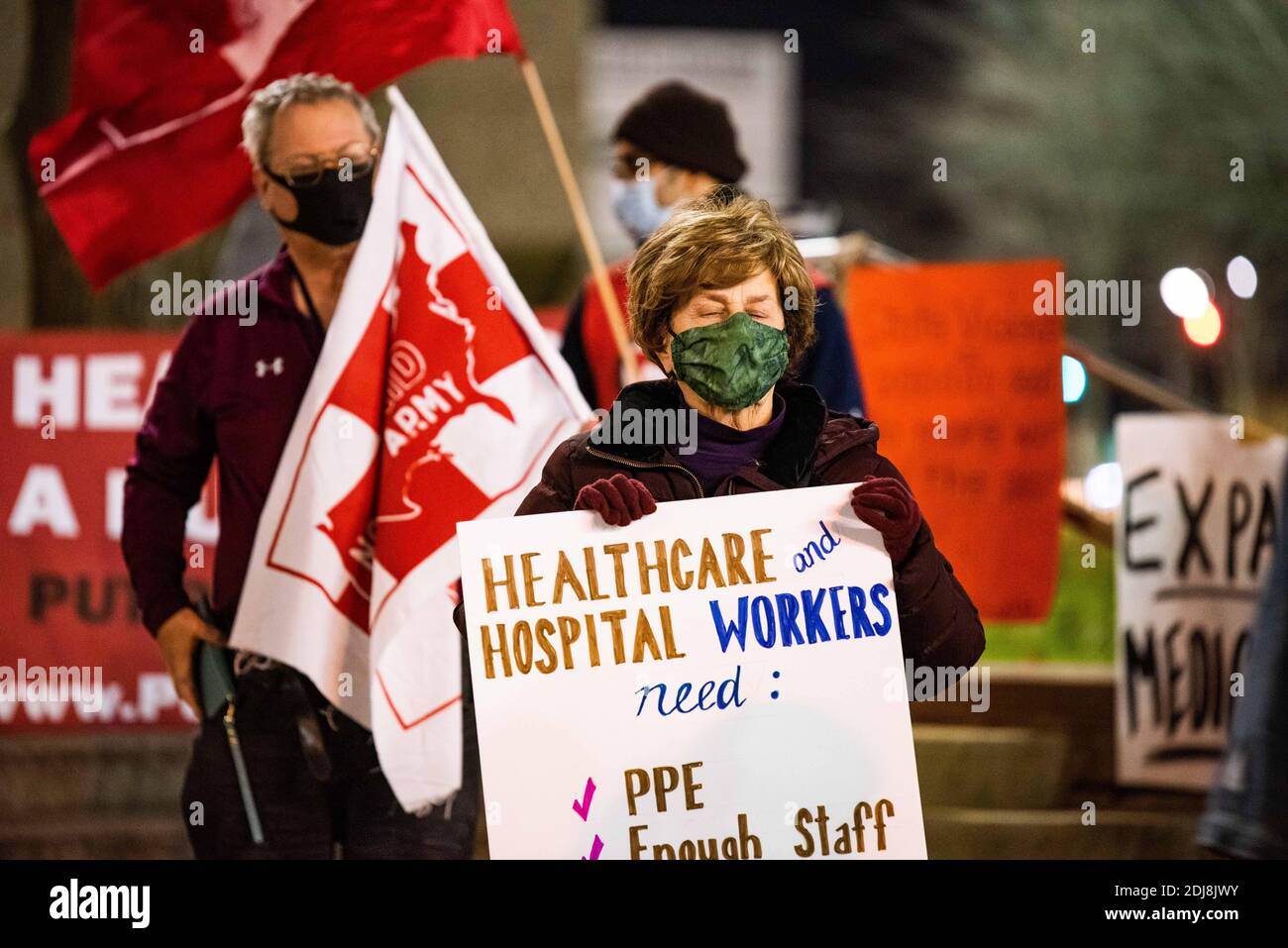 Philadelphia, Pennsylvania, USA. 12th Dec, 2020. Members of the statewide campaign, Put People First-PA, the Nonviolent Medicaid Army and the National Union for the Homeless, gathered in front of Temple University's North Philadelphia hospital campus bringing attention to the extreme pressures healthcare facilities are facing as the Covid-19 pandemic rages across the US, killing over 3000 people a day. The groups claim the root of the crisis is a healthcare system that puts profits over people resulting in short staffing, longer shifts, and inadequate protections. Members also gathered onli Stock Photo