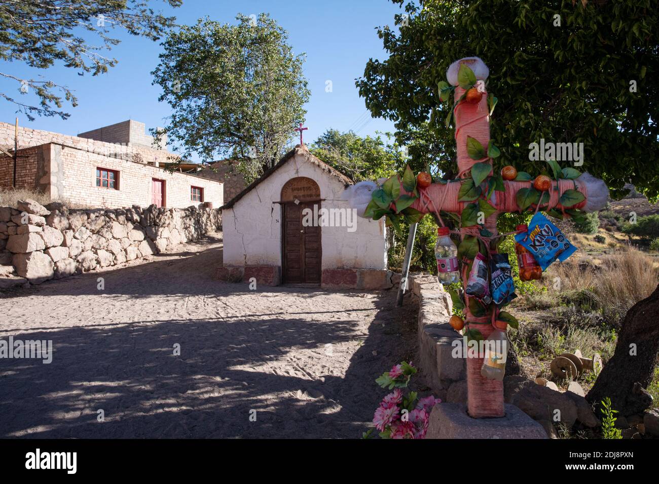 A small church and cross in the Chilean highland village of Caspana, Chile. Stock Photo