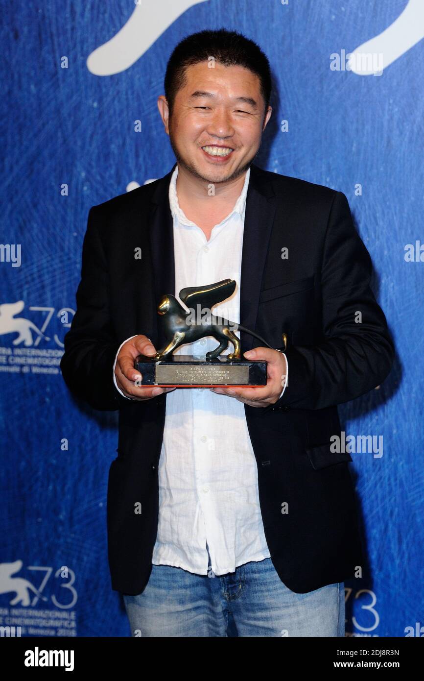 Director Bing Wang poses with the Orizzonti Award for Best Screenplay ...