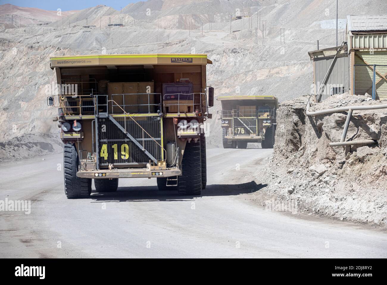 Huge dump trucks working the Chuquicamata open pit copper mine, the world’s largest by volume, Chile. Stock Photo